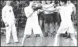  ??  ?? Squaring up: Arthur Jacobs watches Harry Busby boxers (centre) and Joe Rood