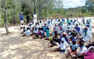  ?? ?? Members of an Apostolic sect attend a meeting on the importance of educating women and girls