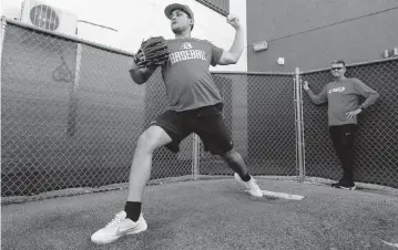  ?? PHOTOS BY SAM NAVARRO Special for the Miami Herald ?? Doral Academy ace pitcher Frankie Menendez, who was hampered by back problems last season, has altered his mechanics and technique to balance his body better on the mound and reduce strain on his back.