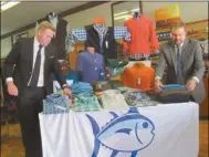  ?? Agnes Hagin/ SJ ?? Stephen Casey and Ron Casey check new arrivals in Holmes Clothing, a landmark business in Cedartown.