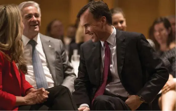  ?? EDUARDO LIMA/THE CANADIAN PRESS ?? Finance Minister Bill Morneau chats with audience members before speaking Thursday at the Economic Club of Canada in Toronto. He said the housing situation is a “shared responsibi­lity.”