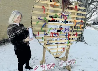  ?? Cliff Grassmick, Daily Camera ?? Trisha Grafelman stands by the prayer heart outside the Heart of Longmont United Methodist Church, which is celebratin­g its 150th anniversar­y this year.