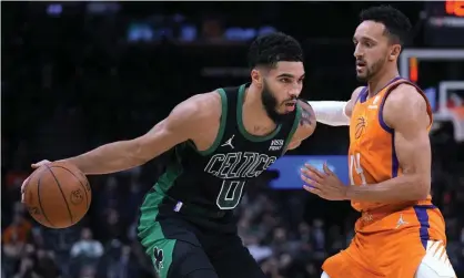  ?? Photograph: Rick Scuteri/AP ?? Celtics forward Jayson Tatum, left was one of 15 players ruled out of Monday night’s Boston-Minnesota game for virus-related reasons alone.