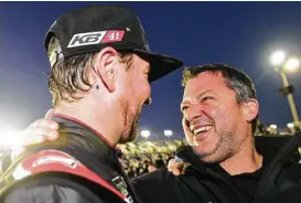  ?? Jared C. Tilton / Getty Images ?? Kurt Busch celebrates with team co-owner Tony Stewart, right. Stewart, a threetime Sprint Cup champ, never won the Daytona 500 as a driver in 17 attempts.