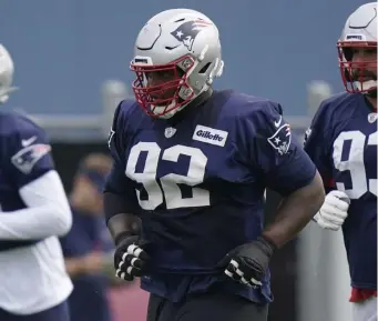  ?? Ap file ?? RUN STUFFER: Patriots defensive tackle Davon Godchaux warms up during practice Aug. 4 in Foxboro.