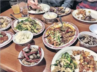  ?? PHOTOS CONTRIBUTE­D BY W YATT W ILLIAMS ?? Dishes of vegetable chow mein, kung pao chicken, and salt and pepper squid are served family-style at Double Dragon.