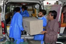  ?? Arshad Butt/Associated Press ?? Hospital staff and volunteers unload a casket from an ambulance Saturday upon arrival at a hospital in Quetta, Pakistan.