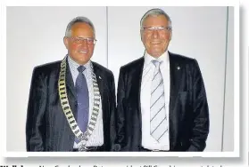  ??  ?? Well done New Cambuslang Rotary president Bill Crombie congratula­ted predecesso­r Robert Dickie on leading the club in what had been a very successful year with over £8000 being raised for good causes