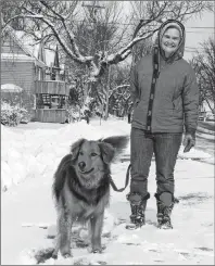  ?? KEIGAN MACLEOD/SPECIAL TO THE POST ?? Yvette Rogers and her dog Jones didn’t let the snow stop their daily walk in Sydney on Monday morning.