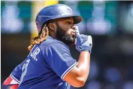  ?? ?? Toronto Blue Jays’ Vladimir Guerrero Jr. gestures after hitting a two-run home run Sunday during a baseball game against the Mariners in Seattle. (AP photo/caean Couto)