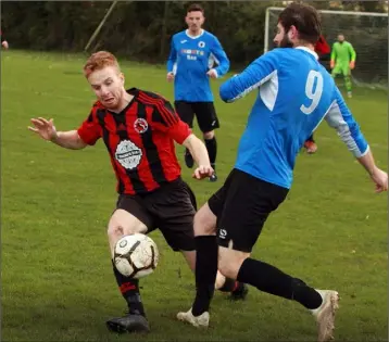  ??  ?? Paul Brennan of Gorey Rangers and Desmond Wolohan of Courtown Hibs battle for possession.