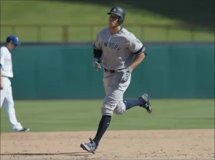  ?? PHOTOS BY LMOTERO— THE ASSOCIATED PRESS ?? New York Yankees Aaron Judge runs the bases after hitting a solo home run during the sixth inning of a baseball game against the Texas Rangers in Arlington, Texas, Sunday.