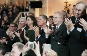  ?? JOSHUA A. BICKEL — THE COLUMBUS DISPATCH VIA AP ?? Former Ohio governors John Kasich, center, Ted Strickland, second from right and Bob Taft, right, applaud during the ceremonial swearing-in of Ohio Gov. Mike DeWine and Lt. Gov. Jon Husted on Monday, January 14 at the Ohio Statehouse in Columbus.
