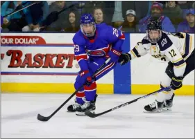  ?? PHOTO BY RICH GAGNON — UMASS LOWELL ATHLETICS ?? Umass Lowell’s Ryan Brushett, left, and Merrimack’s Jordan Seyfert follow the action Friday at the Tsongas Center.