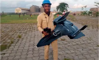  ??  ?? Blaise Awa Chi shows his newly completed model aircraft