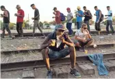  ??  ?? A group of Central American migrants from Honduras and El Salvador wait for a train headed toward the U.S.-Mexico border.