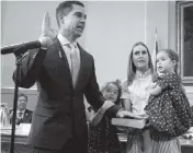  ?? ROBERTO KOLTUN rkoltun@miamiheral­d.com ?? Commission­er Vince Lago, his wife, Olga Mari Lago, and children Catalin y Mirentxu during Friday’s swearing-in ceremony.