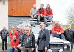  ??  ?? Handover The Lomond Mountain Rescue team with St John Scotland Dunbartons­hire chairman John Kelly
