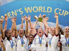  ?? Alessandra Tarantino / Associated Press ?? Megan Rapinoe lifts the trophy after winning the 2019 World Cup final. Rapinoe and others spearheade­d the fight for equal pay.