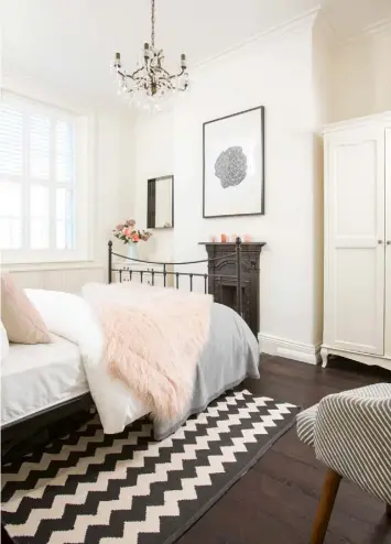  ??  ?? GUEST BEDROOM The oak floor continues into the spare room, which features a Highgrove bed from Feather & Black. A black and white rug brings a modern twist ENSUITE The Burlington basin from Victorian Plumbing and Metro wall tiles from Walls & Floors create a traditiona­l feel