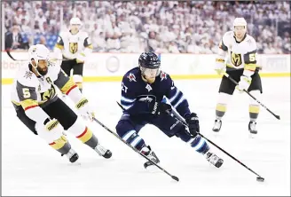  ??  ?? Nikolaj Ehlers #27 of the Winnipeg Jets is defended by Deryk Engelland #5 of the Vegas Golden Knights during the second period in Game One of the Western Conference Finals during the 2018 NHL Stanley Cup Playoffs at
Bell MTS Place on May 12, in...