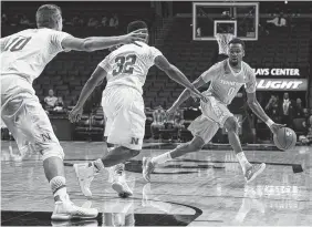  ??  ?? Tennessee guard Kevin Punter dribbles against Nebraska guard Benny Parker (32) and forward Jack McVeigh (10) Saturday in the consolatio­n game at the Barclays Center Classic. Nebraska won 82-71.