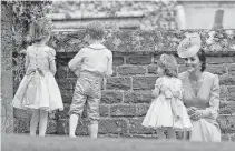  ??  ?? Kate, Duchess of Cambridge, enjoyed the festivitie­s with her children Princess Charlotte, second right, and Prince George, who were flower boys and girls at the wedding.