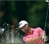  ?? (AP/Ashley Landis) ?? Taylor Moore blasts from a bunker on the seventh hole Friday during the second round of the Masters. The former University of Arkansas golfer finished with a 3-over 75 and sits at 2 over for the tournament heading into today’s third round.