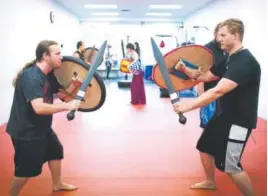  ??  ?? Michael Scanlon, left, and James Harshberge­r train at Ironside Medieval Combat in Colorado Springs.