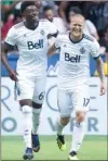  ?? The Canadian Press ?? Vancouver Whitecaps' are hoping Alphonso Davies, left, (with Marcel de Jong celebrate Davies) will be as hot against New York as he was against Minnesota United last weekend when he scored two goals.