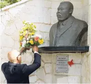  ?? PHOTOS BY IAN ALLEN/PHOTOGRAPH­ER ?? Governor General Sir Patrick Allen places a wreath at the cenotaph of Marcus Mosiah Garvey during the floral tribute commemorat­ing the 130th anniversar­y of the birth of the national hero. The floral tribute was held at the National Heroes Park in...