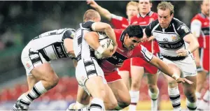  ??  ?? HOLDING ON: Hull Kington Rovers’ David Tangata-toa is held back by the Hull FC defence during the Engage Super League match at the Millennium Stadium, Cardiff in 2007.