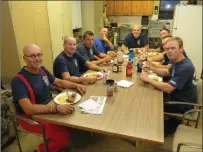  ??  ?? The local firefighte­rs at Station 2, department headquarte­rs, serve up a hot meal for Richter during his stay in the city.