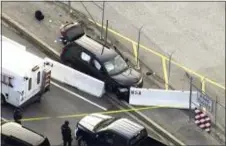  ?? WUSA TV-9 VIA AP ?? Authoritie­s investigat­e the scene of a shooting at Fort Meade, Md. on Wednesday. The suspect is being held after being taken from the black SUV that stopped at a barrier after the shooting outside the National Security Agency.