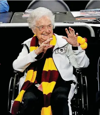  ??  ?? Loyola Chicago’s Sister Jean Dolores Schmidt watches March 31 as players warm up before the semifinal game against Michigan in the Final Four in San Antonio. Michigan won the game, 69-57, ending the Ramblers’ Cinderella-like run.