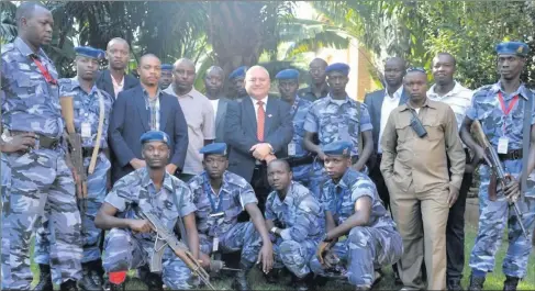  ??  ?? Kieran Holmes pictured with his protection team in Burundi