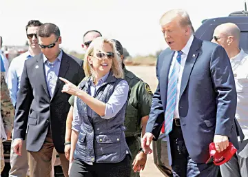  ??  ?? Nielsen (centre) and commission­er for Customs and Border Patrol Kevin McAleenan (left) walk with Trump during a visit to a section of the border wall in Calexico California, US. — Reuters photo