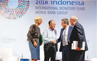  ?? AP ?? From left: IMF Managing Director Christine Lagarde, World Bank President Jim Yong Kim, WTO Director-General Roberto Azevêdo and OECD Secretary-General Angel Gurría at the IMF-World Bank meeting in Bali yesterday. Pakistan is likely to seek an IMF bailout as its economy falters.