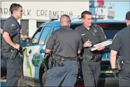  ?? TIM MARTIN/THE DAY ?? New London police officers investigat­e a disturbanc­e at Ocean Beach Park in New London on Saturday.