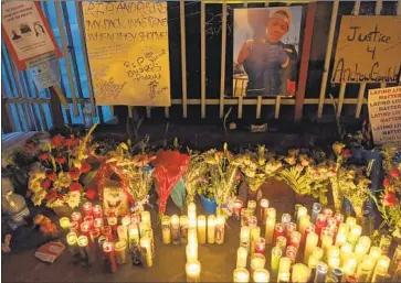  ?? Damian Dovarganes Associated Press ?? A MEMORIAL for Andres Guardado in Gardena last year. An investigat­ion found that from 2015 to 2020, Latinos died at a rate of 23 per million residents after encounters with police, second only to Black people.