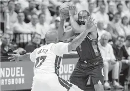  ?? DANIEL A. VARELA dvarela@miamiheral­d.com ?? Heat forward P.J. Tucker defends 76ers guard James Harden during the second half of Game 1 on Monday in Miami. Per ESPN, 12 of Harden’s 13 shot attempts were contested.