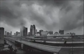  ?? JOE BURBANK/ORLANDO SENTINEL FILE PHOTOGRAPH ?? Storms clouds move in over the skyline of downtown Orlando as Hurricane Irma makes its way up the Florida peninsula on Sept. 10, 2017.