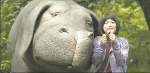  ?? COURTESY OF NETFLIX ?? Seo-Hyun Ahn as Mija and the super-pig Okja in a scene from “Okja.”