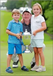  ?? CHUCK BURTON/AP PHOTO ?? Brandt Snedeker poses with the trophy and his children Lilly, right, and Austin, left, after winning the Wyndham Championsh­ip on Sunday in Greensboro, N.C..