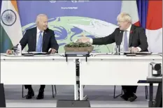  ?? AP pool photo / Steve Reigate ?? President Joe Biden and British Prime Minister Boris Johnson attend the COP26 Summit, at the SECC in Glasgow, Scotland on Tuesday. The U.N. climate summit in Glasgow gathers leaders from around the world, in Scotland’s biggest city, to lay out their vision for addressing the common challenge of global warming.