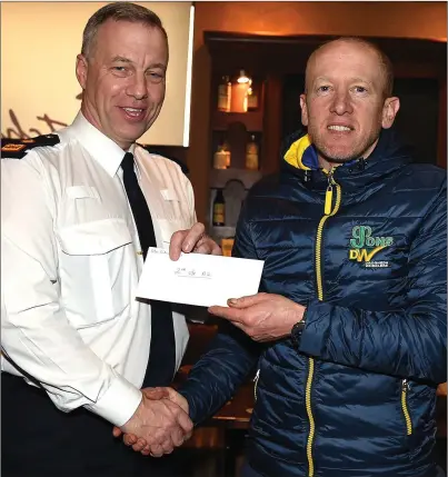  ?? Picture: Colin Bell ?? Chairperso­n Andrew Watters presents Drogheda Wheelers’ Barry Hughes with his second-place prize for unplaced A2 rider in the Peter Bidwell Memorial cycle race at Donore the weekend before last.