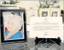  ?? ?? A note from President Joe Biden is seen placed among photos of Primetta Giacopini, who died of COVID-19 on Sept. 16 at 105.