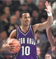  ?? Associated Press file photo ?? Seton Hall’s Shaheen Holloway waves during a 2000 NCAA tournament game. Holloway now coaches Saint Peter’s, which plays at UConn on Wednesday night.