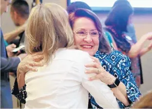  ?? STEPHEN M. DOWELL/STAFF PHOTOGRAPH­ER ?? Teresa Jacobs hugs a supporter at her victory party at MetroWest Golf Club in Orlando on Tuesday night. The Orange County mayor easily cruised to victory as the new chair of the Orange County School Board.