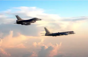  ??  ?? Photo taken and released by Taiwan’s Defence Ministry shows Taiwan’s F-16 fighter (left) jet monitoring one of two Chinese H-6 bombers that flew over the Bashi Channel south of Taiwan and the Miyako Strait, near Japan’s Okinawa Island. — AFP photo